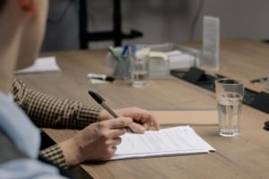 Client reviewing real estate documents in a modern office, focused on residential property transactions and investment strategies.