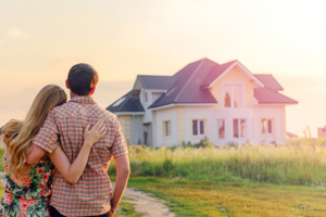 Couple standing in front of a house