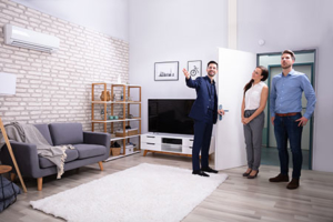 real estate agent showing couple the inside of a house