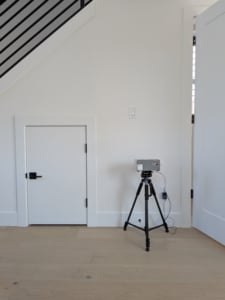 Modern home interior featuring sleek white walls, unique storage door, ideal for showcasing Portland real estate's stylish designs. Testing for radon during a home inspection.