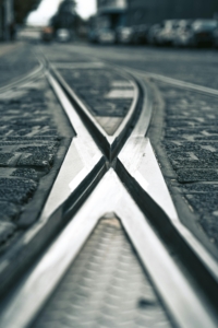 Two rail lines from the Portland streetcar cross in the street.