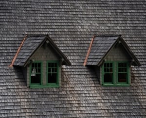 Charming gabled windows on a shingle-roofed single-family home, showcasing classic Portland architecture and inviting curb appeal.