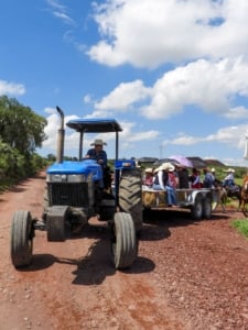 Tractor transporting visitors on a farm, highlighting rural living and community lifestyle in Portland real estate.
