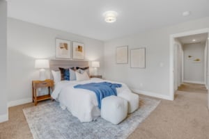 Cozy primary suite featuring modern decor, plush carpeting, and a serene ambiance in a Portland residential property.