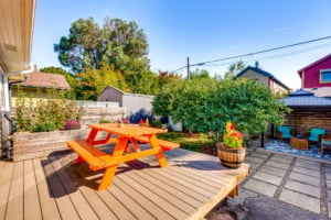 Bright outdoor space featuring a vibrant picnic table, landscaped garden, and cozy seating area for entertaining in Portland.