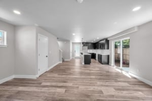 Modern open-concept living space showcasing sleek kitchen features and natural light, ideal for Portland real estate buyers.