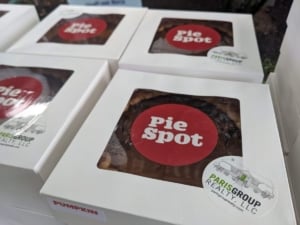 Delicious pumpkin pie boxes from Pie Spot, showcasing community engagement by Paris Group Realty in local Portland events.