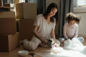 A mother and daughter packing in their new home, showcasing the joy of moving into a single-family residence in Portland.