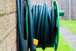 Well-maintained garden hose reel, enhancing outdoor space functionality for Portland homeowners and ideal for backyard landscaping.