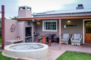 Charming outdoor patio featuring a rustic barbecue, cozy seating, and a peaceful fire pit for entertaining in Portland homes.